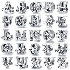 the alphabet is made up of silver letters with swirly designs and diamonds on them