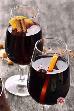 Festive glasses of mulled wine with cinnamon sticks and orange slices, perfect for cozy winter celebrations.