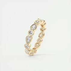 a yellow gold ring with diamonds on it