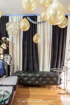 a living room filled with furniture and balloons