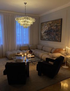 a living room filled with furniture and candles