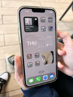 a person holding an iphone in their hand with the screen showing various things on it