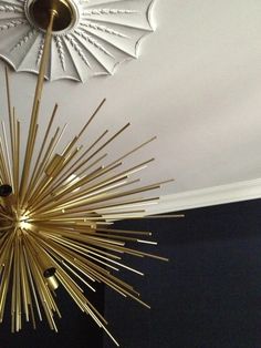 a gold chandelier hanging from the ceiling