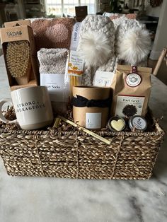 a wicker basket filled with coffee, tea bags and other items on top of a table