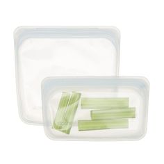 two plastic containers filled with celery stalks