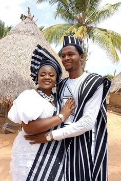 a man and woman dressed in traditional african clothing