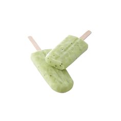 two popsicles with toothpicks sticking out of them on a white background