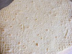 an uncooked tortilla sitting on top of a cutting board