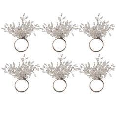 six silver rings with small white flowers on each one and an open ring in the middle