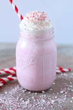 a candy cane milkshake in a mason jar