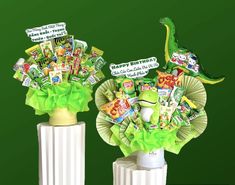 two vases filled with candy and candies on top of each other in front of a green background