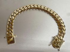 Very impressive solid 14K gold authentic Miami Cuban link bracelet. Made by a Cuban American artist, who specialized in hand crafting Cuban links for over two decades. As you can see in our images, our Cuban links are made thicker and curvier than most Cuban links available online! All our 14K gold Cuban links are made from 14K Plumb (14K+ pure) gold. Bracelet looks even better in person! Bracelet Specs: - 8.5 inches long. - 12mm wide. - Weight Approximately 105.4 grams of solid 14K gold. This is a custom made Cuban links chain listing, and the indicated weight is approximate. The final weight might end up a bit less after production, which in this case we refund the weight difference back to the buyers initial form of payment according to the price per 14K gram of the finished product, So Gold Cuban Link Chain, Cuban Link Bracelet, Mens Jewellery, Miami Cuban Link Chain, Miami Cuban Link, Mens Gold Bracelets, Indian Jewelry Sets, Gold Chains For Men, Miami Cuban