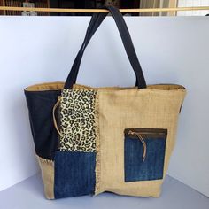 Two in one shoulder handbag! This is a double-sided large shoulder tote bag  patchwork, combining denim, animal print ,burlap, wool fabrics. One side is plain black fabric with animal print beige details and the other side is, one half a patchwork design with denim ,elegant animal print in beige and black and the other half burlap fabric with a denim pocket with zipper.  Notice all the details where the pieces connect to eachother. All pockets are zippered There is also a  hanger to hang your ke Casual Hobo Tote Bag With Patchwork, Everyday Patchwork Hobo Tote Bag, Casual Patchwork Hobo Tote Bag, Patchwork Hobo Tote Bag, Casual Burlap Shoulder Bag For Everyday, Denim Patchwork Tote Bag, Tote Bag Patchwork, Jean Tote Bag, Noir Uni