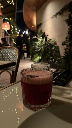 a drink sitting on top of a white table