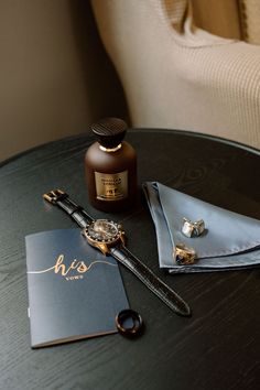 a grooms vows, watch, vanilla+tobacco cologne, wedding band and cufflinks sit on a dark wood table side a blue-grey pocket square. Wedding Details Photography Groom, Men’s Getting Ready Wedding, Groom Flatlay, Groom Detail Shots, Grooms Details, Wedding Accessories Photography, His Wedding Band, Glacier Elopement, Men Wedding Accessories