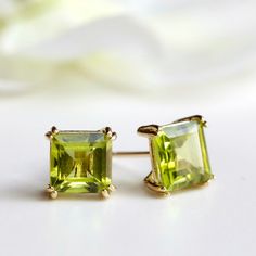 6 MM SQUARE NATURAL PERIDOT STUD EARRINGS IN 9 CARAT YELLOW GOLD * These natural peridot gemstone stud earrings are handset in solid 9-carat yellow gold  4 claw round setting. EARRING SIZE:  6mm Please view the 2nd image for a better perspective of the size * Earrings come complete with 9-carat yellow gold butterfly backs. * Presented in a GEMSTONE GARDEN branded gift box - ready to give or receive.  THE SMALL PRINT Please Note: We cannot accept returns for earrings due to hygiene reasons. Hands Silver Sapphire Necklace, Birmingham Jewellery Quarter, April Birthstone Necklace, Interesting Jewelry, 16th Anniversary, Earrings Square, Sapphire Necklace Pendants, April Birthstone Jewelry, Stud Earrings Silver