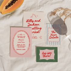 there are some cards that have been placed on top of the paper and next to it is a piece of fruit