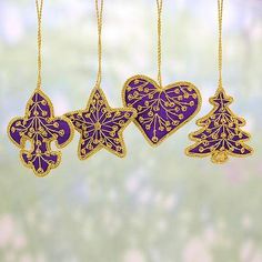 three christmas ornaments hanging from chains with snowflakes on the top and two hearts in the middle