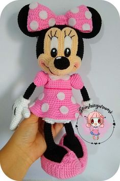 a crocheted minnie mouse doll with pink dress