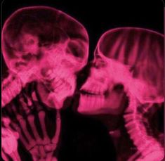 two skeleton heads are shown in red light