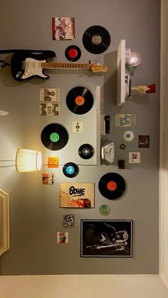 there are many records on the wall and some lights in the room with them attached to the wall