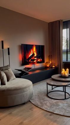 a living room filled with furniture and a fire place in the middle of the room