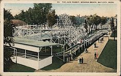 an old postcard shows people walking around the amusement park, which was built in 1932