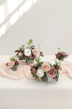 three wedding bouquets sitting on top of a white table