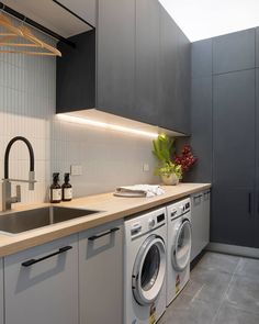 a kitchen with a sink, washer and dryer in it