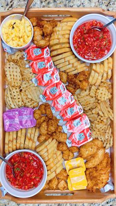 a tray filled with different types of snacks and condiments on top of it