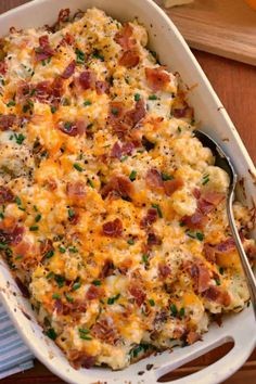 loaded cauliflower casserole with bacon and parsley in a white dish