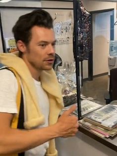 a man standing in front of a counter holding a cell phone