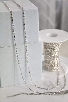 Priced per foot of chain. 1.5mm Sterling Silver Bar Link Chain **We strongly recommend buying at least 2ft (24 inches) at a time so that you can easily cut it down for various necklace sizes.** We recommend charging a minimum of $4 per inch of this material, but encourage you to price higher to maximize profitability. PRODUCT SPECIFICATIONS: Metal Color Silver Metal Type .925 Sterling Silver Shape Bar Chain Thickness 0.4mm Width 1.5mm Silver Cable Chain Jewelry For Party, Silver Jewelry With Cable Chain For Party, Silver Delicate Chain Necklace For Party, Party Delicate Silver Chain Necklace, Silver Beaded Chain Necklace For Wedding, Wedding Silver Beaded Chain Necklace, Silver Necklaces With Satellite Chain For Parties, Party Necklaces With Silver Satellite Chain, Beading Tools