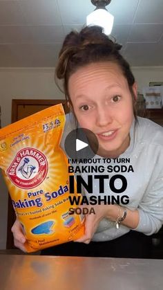 a woman holding up a bag of baking soda