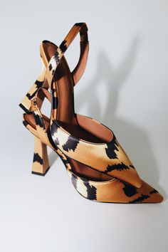 Add some glam to your wardrobe with our FARAH sling backs. Featuring a 4" sculptured heel and an abstract tiger satin tiger print fabric. Size and Fit Information: U.S. Sizing Available in whole and half sizes Runs true to size, but some people have gone a half size down for a more secure fit with the slingback (Note: Not using leather and other materials from animals significantly reduces environmental impact, however, we acknowledge that synthetic alternatives are not without environmental con Brown Slingback Pumps With Sculpted Heel For Party, Brown Slingback Pumps With Wrapped Heel For Party, Luxury Brown Slingback Pumps For Party, Leopard Print Pointed Toe Heels For Evening, Spring Evening Leopard Print Heels, Leopard Print Evening Heels For Spring, Leopard Print High Heel Evening Heels, Evening Leopard Print High Heels, Leopard Print Heels For Spring Formal