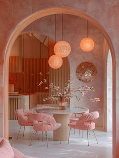 an archway leading to a dining room with pink chairs and round table in the center