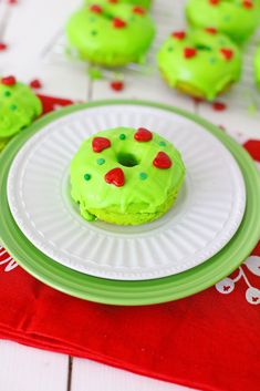 green frosted doughnuts with sprinkles on a white and green plate