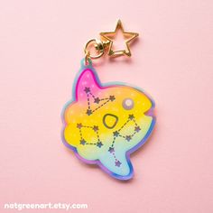 a keychain with an image of a fish on it's face and stars in the background