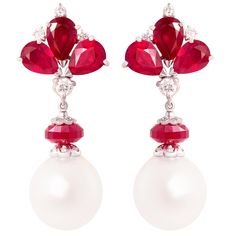 The ruby and diamond earrings feature 6 faceted drop shape African rubies of homogeneous brilliant color for a total of approximately 12 carats. A mid-section set with diamonds (0.70 carats) suspends –via a ruby bead- 2 lustrous South Sea pearls of 16.5mm. All of our pearls are untreated: their natural color and high luster have not been enhanced in any way. The elegant earrings are flexible just to the right extent. They were entirely hand made in 18 carat gold by maestro Scalabri in our own wo Luxury Red Pearl Earrings, Elegant Style, Luxury Red Pearl Earrings For Wedding, Luxury Pearl Drop Ruby Jewelry, Luxury Ruby Jewelry With Pearl Drop, Luxury Red Pearl Earrings For Formal Occasions, Luxury Red Pearl Earrings For Gift, Luxury Red Jewelry With Pearl Drop, Luxury Red Pearl Earrings Elegant, Luxury Red Pearl Earrings As Gift