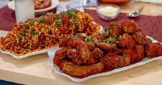 two plates filled with food on top of a wooden table