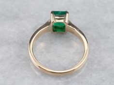 The mounting of this ring is vintage, crafted of a perfect, 18 karat yellow gold. We've set it with a gorgeous emerald that looks amazing surrounded by the bright polish of the prongs! Shades of green simply gleam from this gorgeous ring!Metal: 18K Yellow Gold Gem: Emerald 1.295 CaratsGem Measurements: 6.9 x 6.3 mm, Emerald Cut Ring Size: 6.50Marks: “18K” Stamped on the inside band Heirloom Green Emerald Solitaire Ring, Classic 14k Gold Emerald Ring With Tension Setting, Timeless Green Emerald Ring Stamped 14k, Classic Yellow Gold Emerald Ring With Asscher Cut, Classic Green Asscher Cut Rings, Classic Yellow Gold Emerald Ring With Tension Setting, Classic Solitaire Emerald Ring For May Birthstone, Classic Solitaire Emerald Ring, May Birthstone, May Birthstone Princess Cut Emerald Ring In Yellow Gold