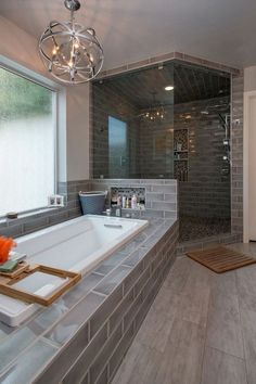 a bathroom with a large bathtub next to a walk in shower