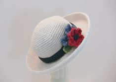 a crocheted hat with flowers on it