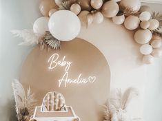 a baby's room with balloons and decorations on the wall