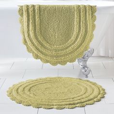 a bath tub sitting next to a rug on the floor