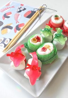 sushi rolls on a plate with chopsticks next to it