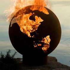 a fire pit with the earth on it's side