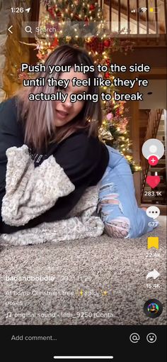 a woman laying on the ground next to a christmas tree with an instagram message