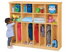 Our super-accessible center lets little ones hang up coats and backpacks all by themselves! It features storage space for up to 8 children, with 8 big cubbies on top that are roomy enough for diaper bags, blankets and more�plus 8 easy-access lockers below, all with rounded wooden pegs to keep children safe. Center measures 58"w x 13 3/4"d x 49"h. Daycare Cubbies, Preschool Cubbies, Kids Locker, Home Lockers, Coat Storage, Storage Center, Cubby Storage, Flexible Seating, Classroom Furniture