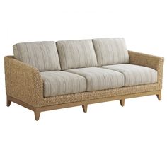 an image of a couch that is made out of wood and wicker with cushions